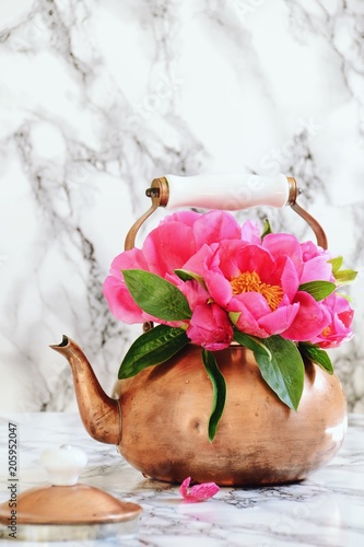 Peony flowers in the copper kettle