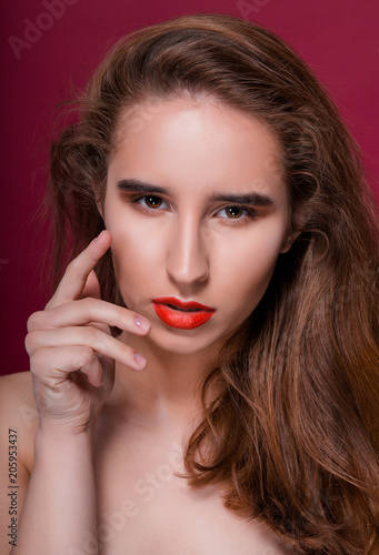 Beauty portrait of young attractive model with clean skin and red lips