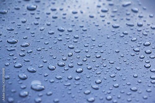Water drops on a metalic grey car background