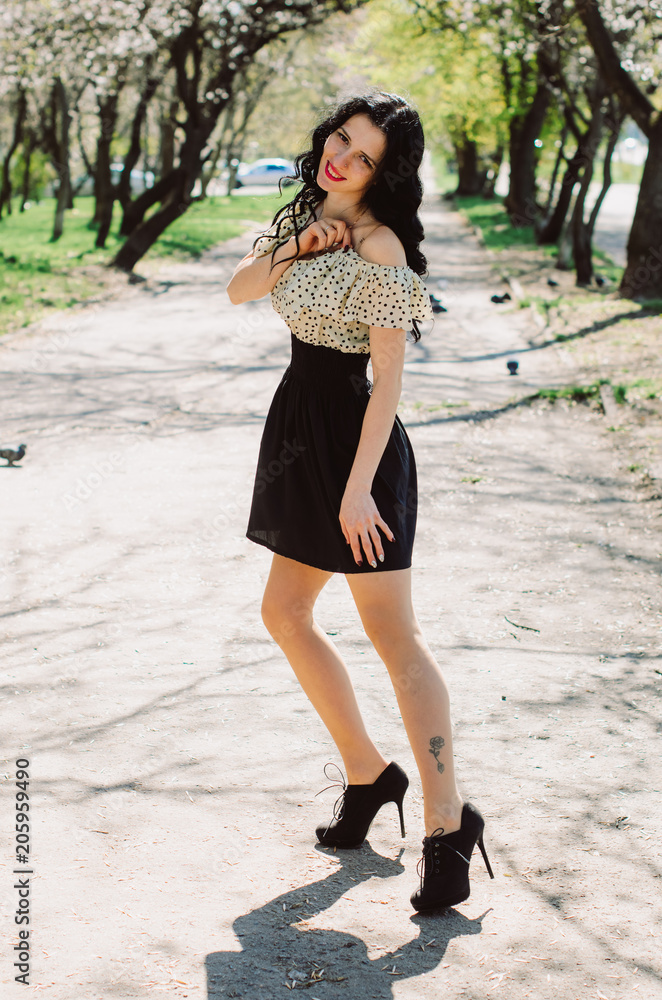 Beautiful Girl, brunette with red lips. Spring , shooting in the Park .