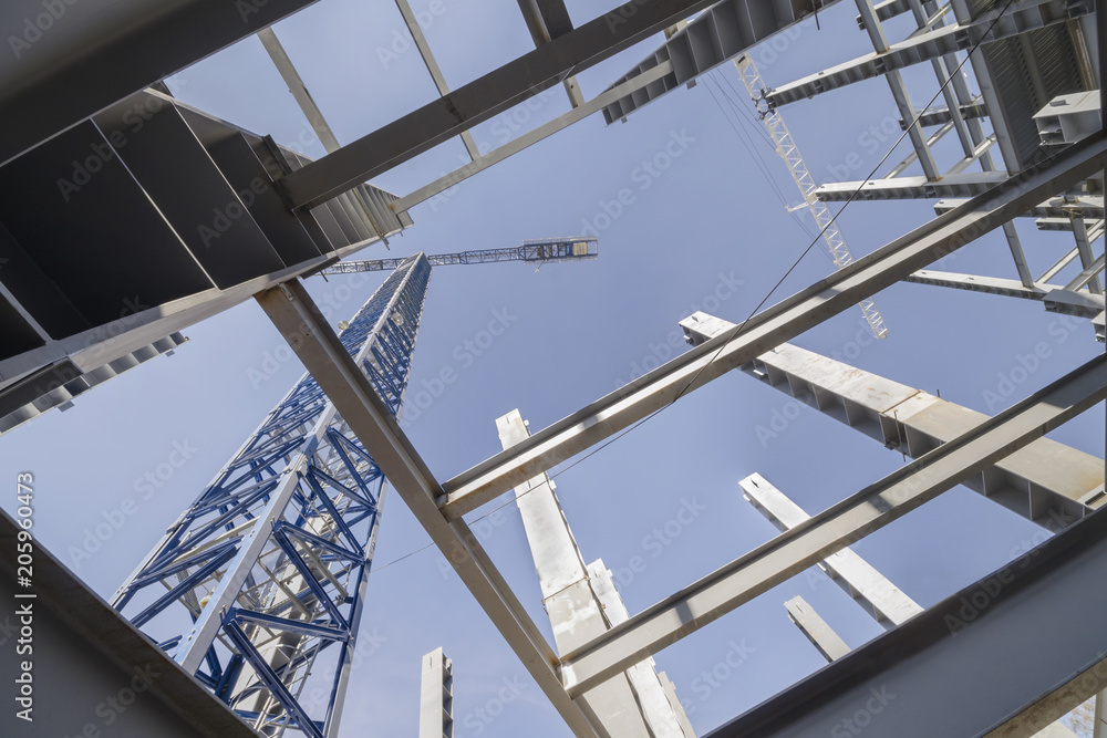 Low-angle shot of a several metal columns and girders of a construction site Low-angle shot of a several metal columns and girders of a construction site