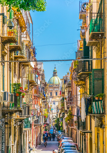 View of a narrow street leading to chiesa del carmine maggiore in Palermo, Sicily, Italy photo
