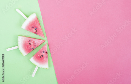 three watermelon slices on red background