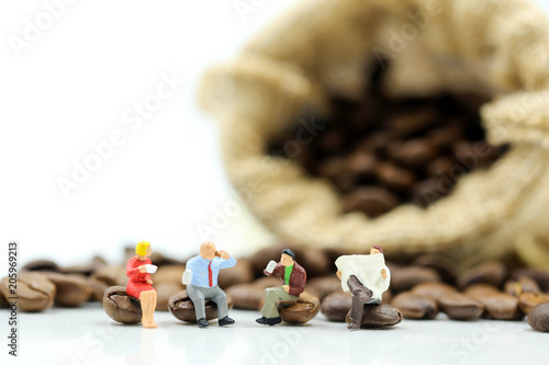 Miniature people : business team sitting on coffee beans,relax concept.