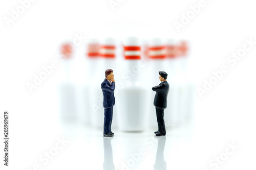 Miniature people : businessman with bowling pin and ball,Business competition concept Fighting and confronting problems.