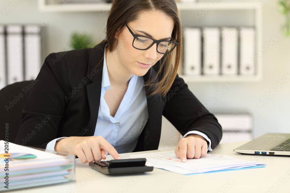 Bookkeeper calculating using a calculator Bookkeeper calculating using a calculator