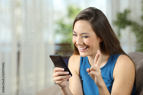 Free Download Hopeful woman waiting for online news in a smartphone - GFXLoad