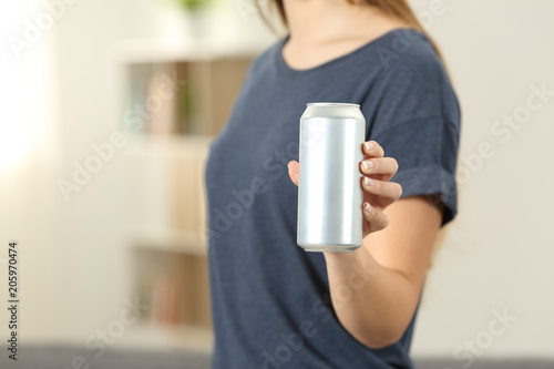 Closeup of a woman hand holding a soda drink can