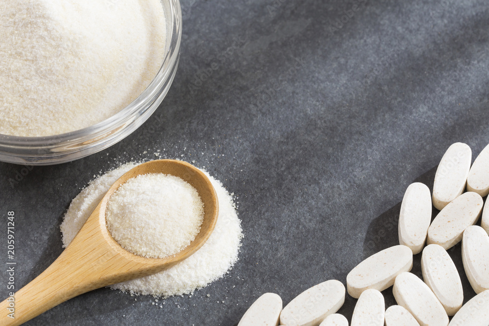 Pills and collagen protein powder in the spoon - Hydrolyzed Pills and collagen protein powder in the spoon - Hydrolyzed