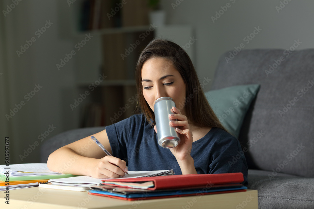 Student studying hard drinking an energy beverage Stock Photo Adobe Stock