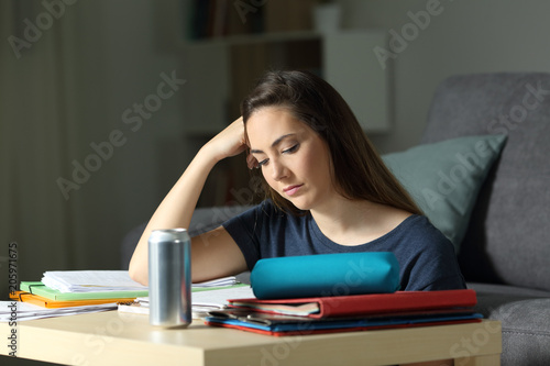 Student studying hard in the night at home