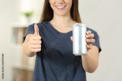 Woman hands holding a soda drink can with thumbs up