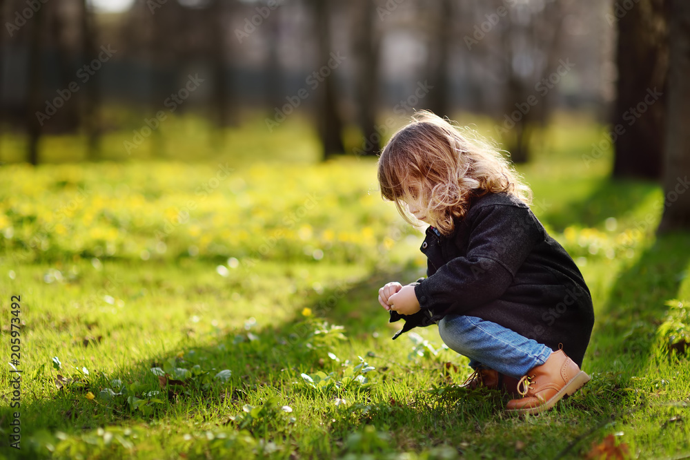 Cute little girl outdoors portrait in spring sunny day