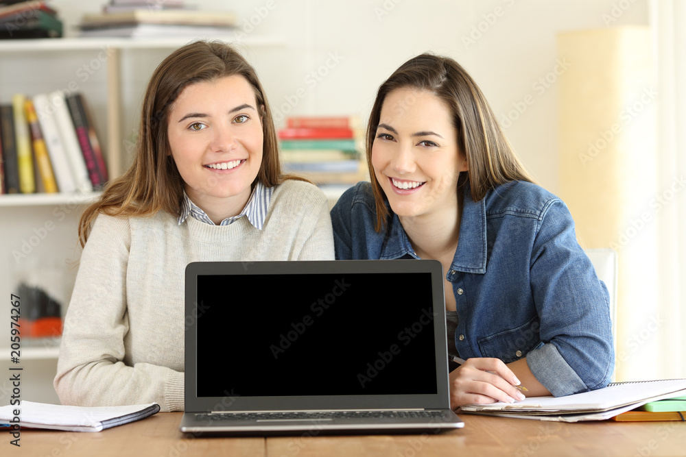 Two students showing a laptop screen mockup Two students showing a laptop screen mockup