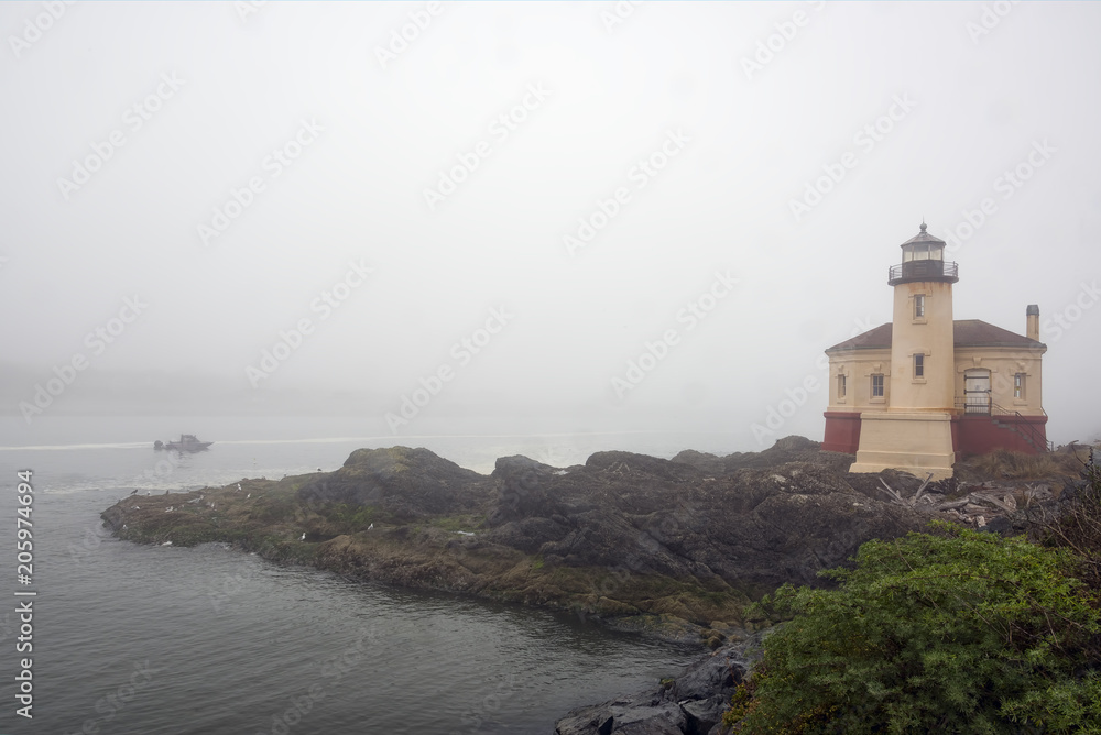 Heavy fog surrounds the Coquille River Lighthouse and the surrounding landscape near Bandon, Oregon Heavy fog surrounds the Coquille River Lighthouse and the surrounding landscape near Bandon, Oregon