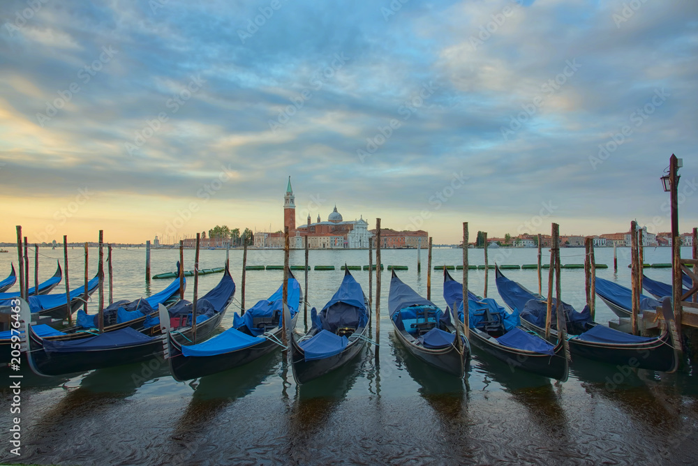 Gondolas in front of the San Giorgio Maggiore church in Venice at sunrise