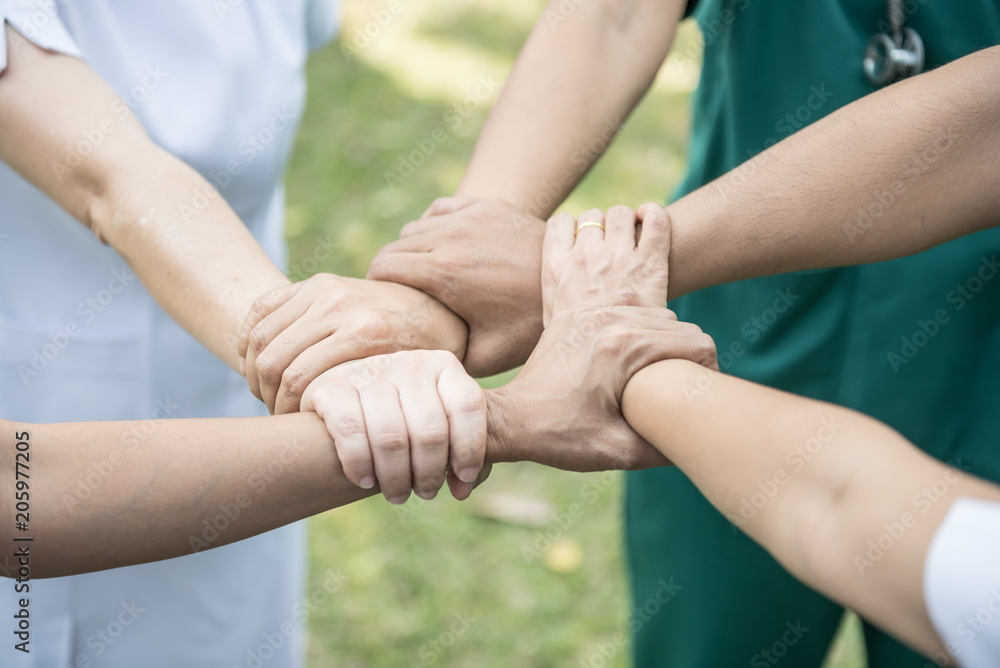 Doctors and nurses coordinate hands. Concept Teamwork Doctors and nurses coordinate hands. Concept Teamwork