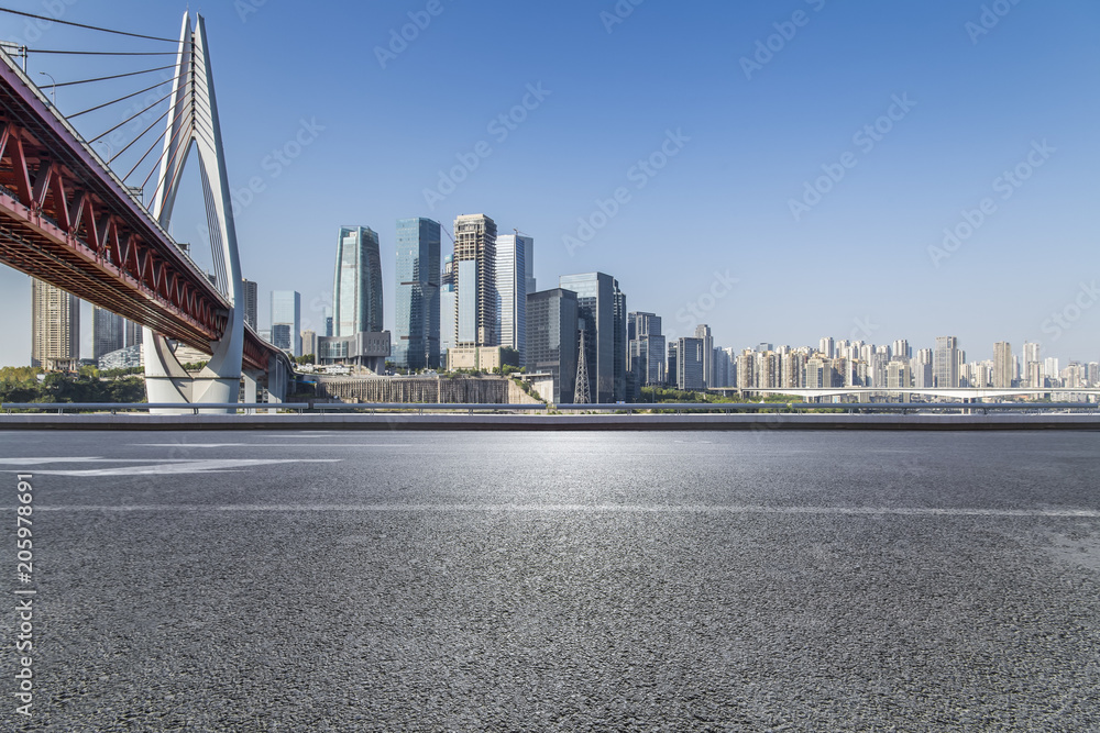Panoramic skyline and modern business office buildings with empty road,empty concrete square floor Panoramic skyline and modern business office buildings with empty road,empty concrete square floor