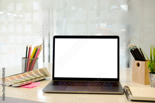 Laptop with blank screen on creative table and studio office © bongkarn