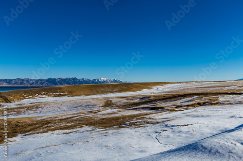   The frozen Sailimu lake with snow mountain background at Yili  Xinjiang of China