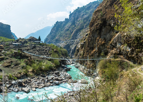 Fototapeta Naklejka Na Ścianę i Meble -  Bridge over the mountain river in Nepal.