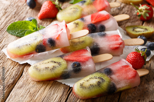 Natural berry-fruit ice with fresh strawberries, blueberries and kiwi fruit close-up. horizontal