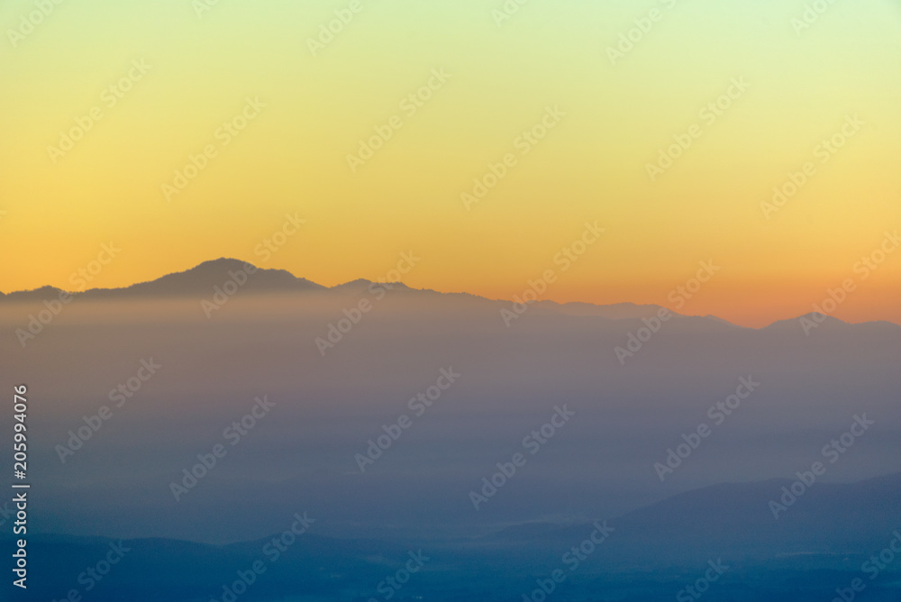 Moutain range and mist at sunrise.