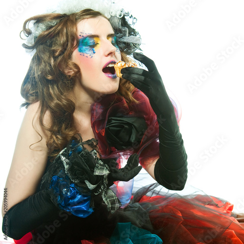  young woman with creative make-up with cake. photo