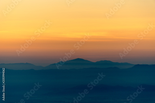 Moutain range and mist at sunrise.
