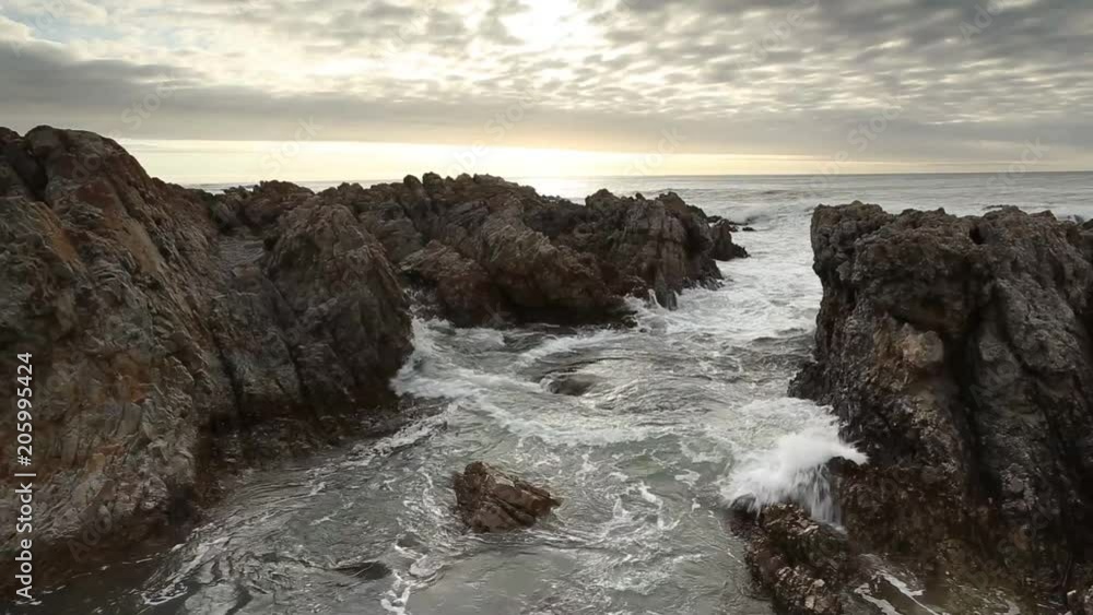 Beautiful sunset view of waves crashing on a rocky cove in Africa. Beautiful sunset view of waves crashing on a rocky cove in Africa.