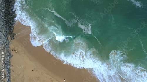 Top down aerial view of skim boarding at The Wedge, popular surf spot in Newport Beach, Orange County, California
