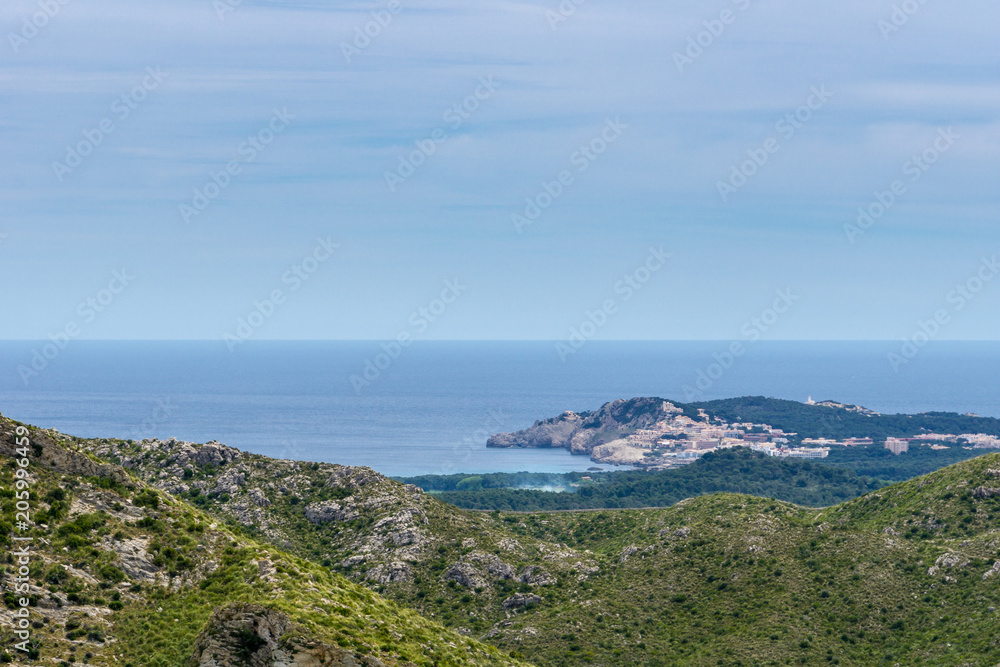 Mallorca, Aerial view on holiday island coast and village at sea with lighthouse from mountains Mallorca, Aerial view on holiday island coast and village at sea with lighthouse from mountains