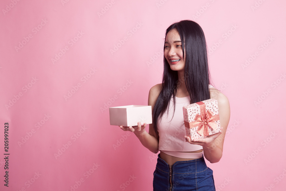 Young Asian woman open a gift box. Young Asian woman open a gift box.