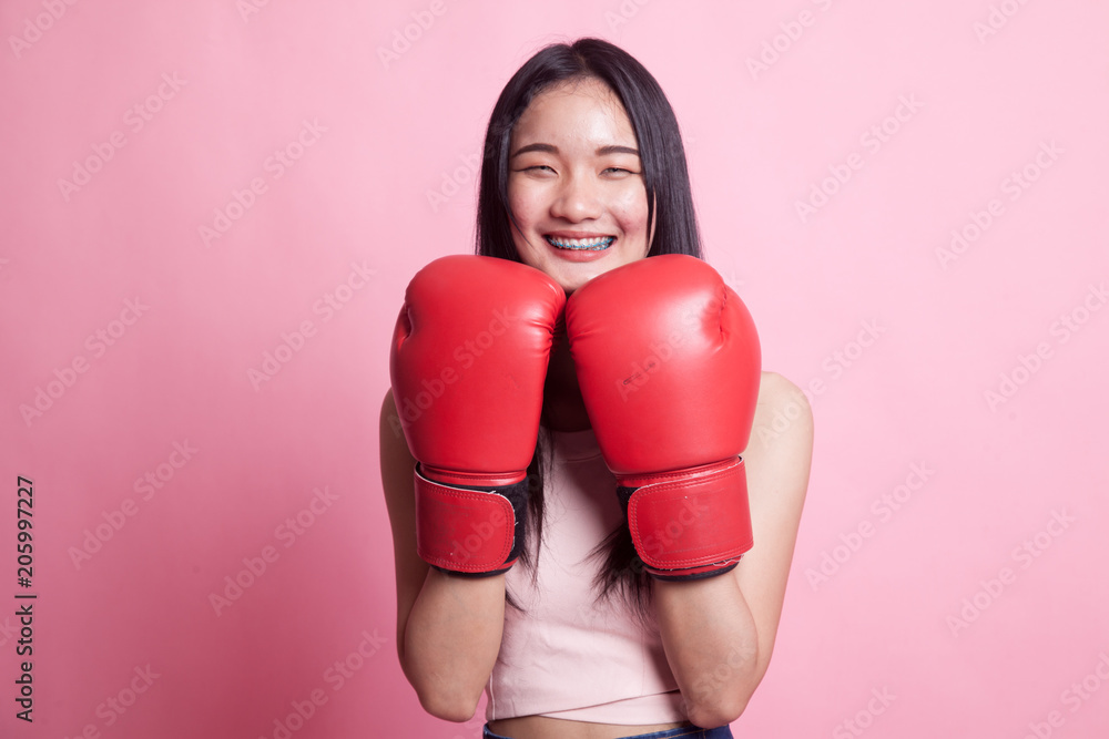 Young Asian woman with red boxing gloves. Young Asian woman with red boxing gloves.