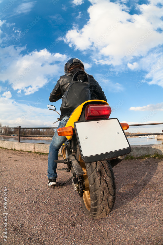 Obraz premium Wide angle view at the back of motorcyclist on bike with clear blank license plate