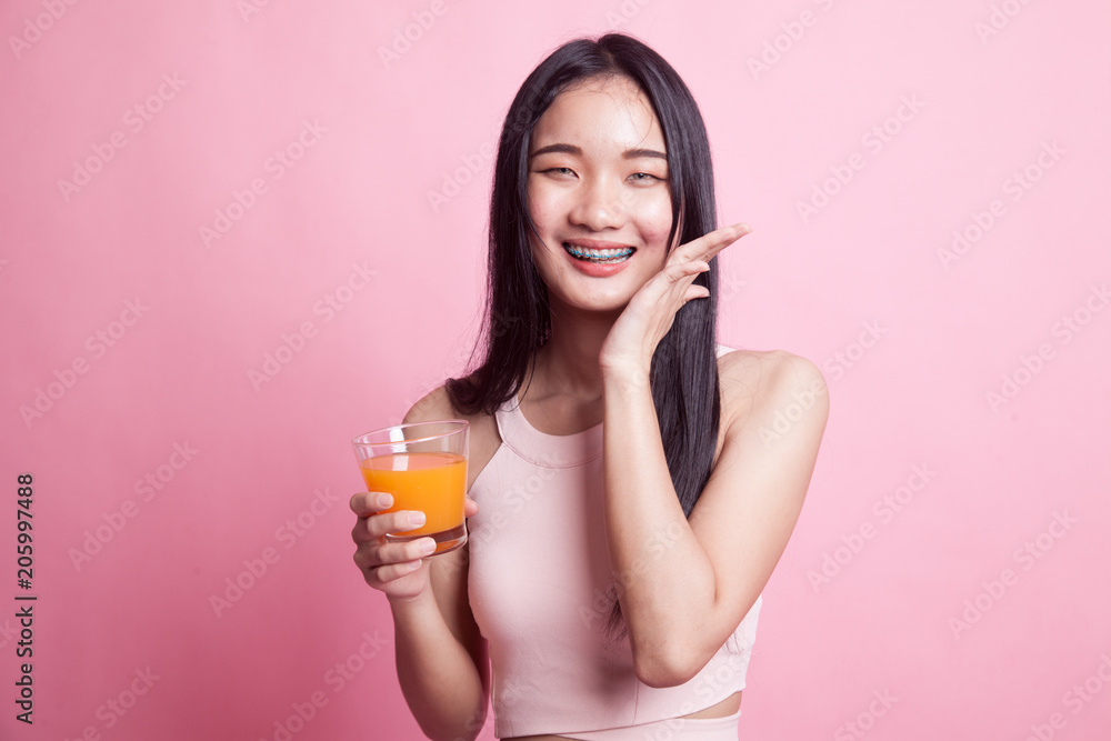 Happy Young Asian woman drink orange juice. Happy Young Asian woman drink orange juice.