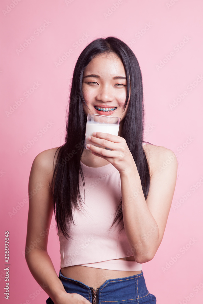 Healthy Asian woman drinking a glass of milk. Healthy Asian woman drinking a glass of milk.