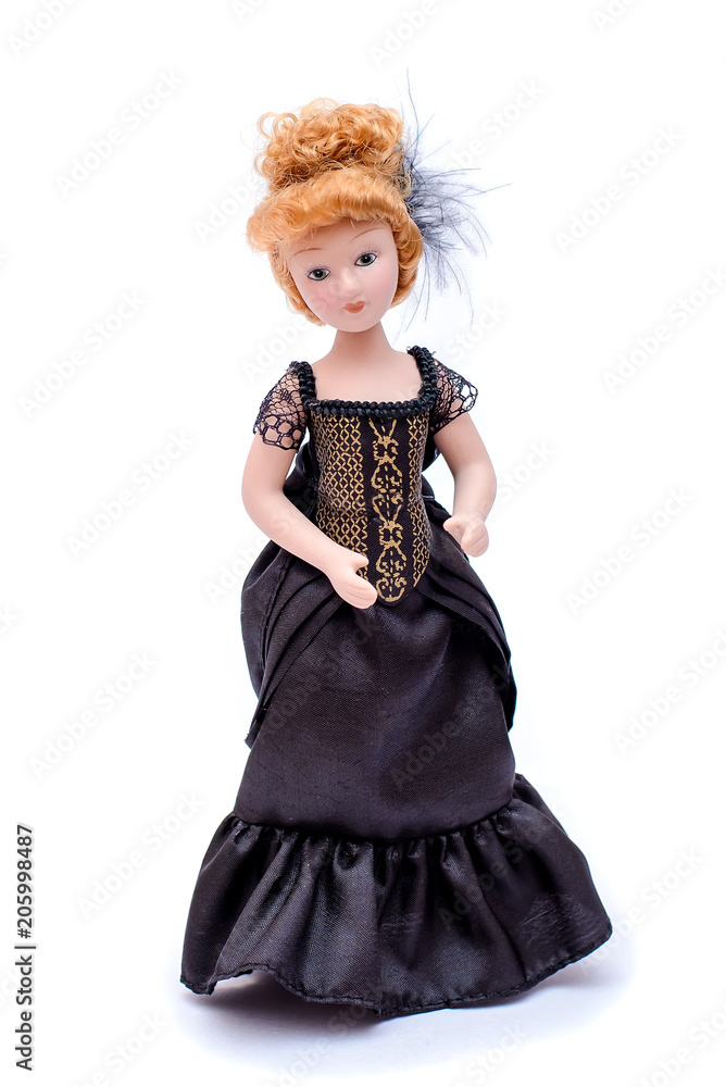 Porcelain doll with red hair in a long black vintage dress Stock