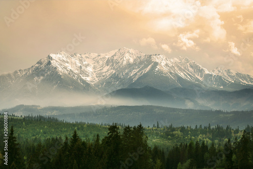 Retro styled picture of high mountains with snow on peaks © agneskantaruk