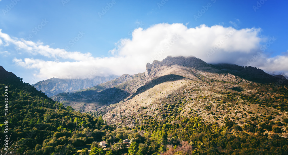 Fototapeta premium Corsica, France, beautiful mountain landscape with clouds and blue sky