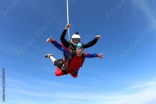 Tandem skydiving. Two men are in the sky.