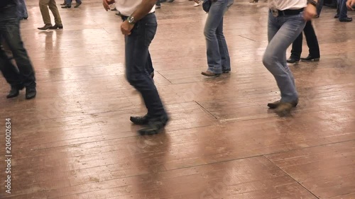 People dancing together at a hoedown party. Denim, cowboy boots and USA flag. Western dancers learning line dance, bluegrass music choreography, country folk festival and tradition of America photo