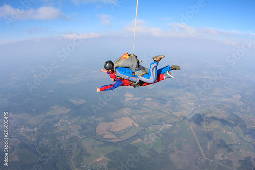 Tandem skydiving. Physically challenged woman is flying in the sky.
