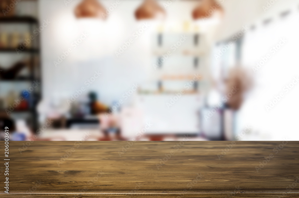 Selected focus empty brown wooden table and Coffee shop blur background with bokeh image. for your photomontage or product display