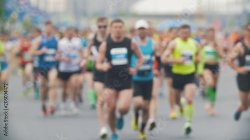 Sportsmen runners at the marathon in the city, blurred, slow-motion