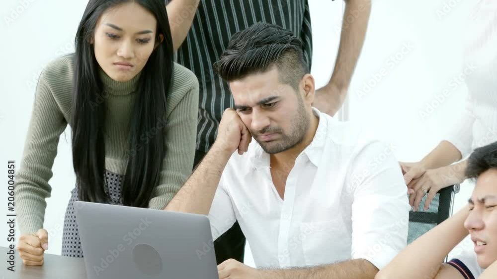 Business people looking to laptop together with unhappy emotion. Business concept. Business people looking to laptop together with unhappy emotion. Business concept.