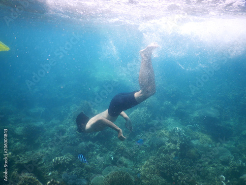 a man snorkeling under the sea