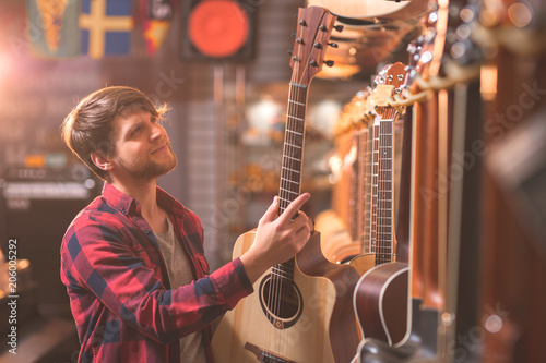A young man chooses a guitar