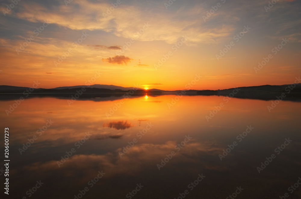 Obraz premium Awesome sunset at the Lipno Dam (Lake). Spring evening. Czech Republic