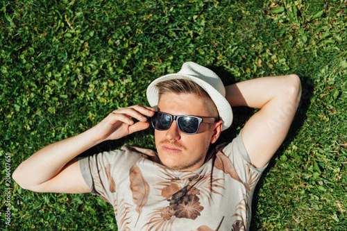 stylish hipster guy lying on the grass © ruslan_shramko
